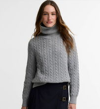 Load image into Gallery viewer, Woman wearing a cable-knit turtleneck sweater with long sleeves and ribbed collar