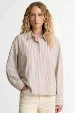 Load image into Gallery viewer, Woman wearing Barbour Fawne striped button-up shirt with relaxed fit and long sleeves