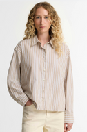 Woman wearing Barbour Fawne striped button-up shirt with relaxed fit and long sleeves
