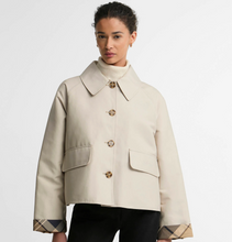 Load image into Gallery viewer, Woman wearing a cropped Barbour Delilah Showerproof Jacket with large buttons and plaid cuffs