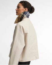 Load image into Gallery viewer, Woman wearing Barbour Delilah Showerproof Jacket with plaid lining visible at collar, back view
