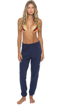 Load image into Gallery viewer, Woman wearing relaxed fit jogger sweatpants with lightning bolt detail on side seam