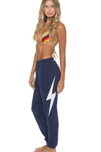 Load image into Gallery viewer, Woman wearing Aviator Nation Bolt Stitch Sweatpants featuring a large lightning bolt graphic on the leg