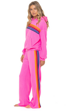 Load image into Gallery viewer, Aviator Nation women's pullover hoodie with rainbow diagonal stripes, paired with matching wide-leg sweatpants