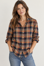Load image into Gallery viewer, Woman wearing a plaid flannel button-up shirt with chest pocket and rolled cuffs