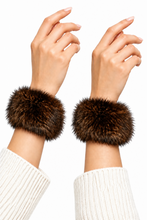 Load image into Gallery viewer, Dark brown fox fur wrist cuffs worn on both wrists over white knit sleeves