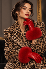 Load image into Gallery viewer, Luxurious patent leather gloves with fluffy fox fur cuffs, styled with elegant leopard coat