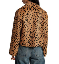 Load image into Gallery viewer, Woman wearing a short cheetah print textured jacket paired with denim jeans, back view
