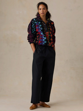 Load image into Gallery viewer, Woman wearing a cozy patterned fleece pullover with snap buttons and collar