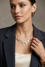 Load image into Gallery viewer, Brackish Zoe Necklace featuring moon phase disc pendants on a gold chain, worn by model