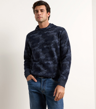 Load image into Gallery viewer, Man wearing a camouflage pattern hooded pullover sweater with jeans