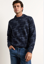 Load image into Gallery viewer, Man wearing a camouflage patterned hooded pullover sweater with jeans