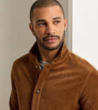 Load image into Gallery viewer, Man wearing a structured corduroy chore coat with button closure and ribbed texture