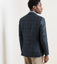 Load image into Gallery viewer, Man wearing a windowpane plaid sport jacket, shown from the back, paired with chinos