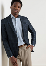 Load image into Gallery viewer, Man wearing a tailored windowpane plaid sport jacket over a dress shirt with chinos