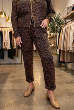 Load image into Gallery viewer, Slim-fit leopard print pants in brown and black with cuffed ankles