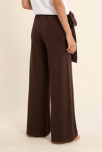 Load image into Gallery viewer, Back view of wide leg knit pants with elastic waistband and flowing silhouette