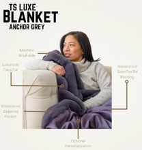 Load image into Gallery viewer, Woman relaxing on sofa with luxurious faux fur waterproof blanket featuring zippered pocket