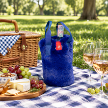 Load image into Gallery viewer, Pretty Rugged faux fur wine tote bag holding a bottle at a picnic setting