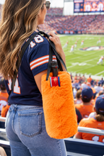 Load image into Gallery viewer, Woman carrying a fluffy faux fur wine tote bag at a football stadium game