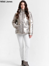 Load image into Gallery viewer, Woman wearing a shiny metallic puffer jacket with front pockets and high collar