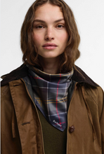 Load image into Gallery viewer, Model wearing Barbour Kinsale Classic Scarf in tartan pattern tied around neck over wax jacket