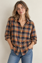 Load image into Gallery viewer, Woman wearing a relaxed-fit plaid flannel button-up shirt with rolled sleeves and jeans