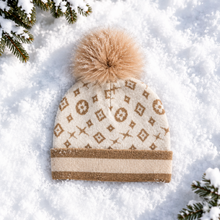Load image into Gallery viewer, Cream knit beanie with gold monogram pattern and fluffy tan fox fur pom-pom