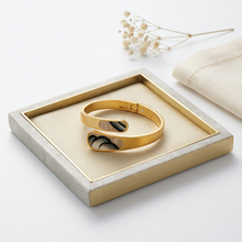 Load image into Gallery viewer, Brackish Lainey Bezel Hinge Cuff featuring feather inlay displayed elegantly on a linen-lined tray