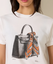 Load image into Gallery viewer, White graphic tee featuring a sketched luxury handbag with silk scarf illustration and 'Carry Me' text
