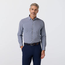 Load image into Gallery viewer, Man wearing a long-sleeve plaid button-down dress shirt tucked into tailored trousers