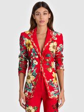 Load image into Gallery viewer, Model wearing a fitted long red floral blazer with gold button closure and peak lapels