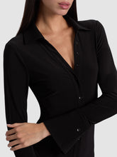 Load image into Gallery viewer, Close-up detail of fitted black button-down dress with V-neckline and long sleeves on model