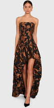 Load image into Gallery viewer, Model wearing strapless high-low floral brocade maxi gown with gathered skirt and train