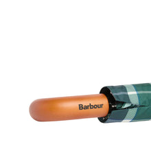 Load image into Gallery viewer, Close-up of Barbour branded wooden handle on a folded tartan umbrella