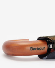 Load image into Gallery viewer, Close-up detail of Barbour-branded wooden crook handle on a folded tartan umbrella