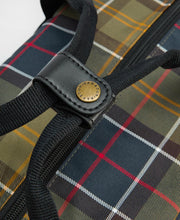 Load image into Gallery viewer, Close-up detail of Barbour branded brass rivet on black leather strap connector of tartan bag