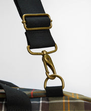 Load image into Gallery viewer, Close-up detail of antique brass snap hook hardware connecting black nylon shoulder strap to tartan bag
