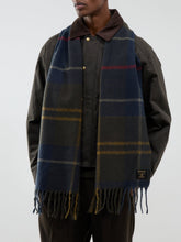 Load image into Gallery viewer, Man wearing Barbour tartan plaid wool scarf with fringe over dark waxed jacket