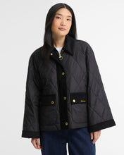 Load image into Gallery viewer, Woman wearing Barbour quilted jacket with gold snap buttons and corduroy trim details