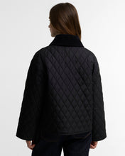 Load image into Gallery viewer, Back view of a women's diamond-quilted jacket with ribbed collar and wide sleeves
