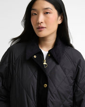 Load image into Gallery viewer, Model wearing a quilted diamond-pattern jacket with corduroy collar and gold zip hardware