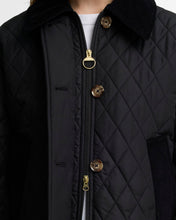 Load image into Gallery viewer, Close-up detail of quilted jacket showing gold zipper, brown buttons, and corduroy collar