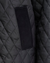 Load image into Gallery viewer, Close-up detail of Barbour quilted jacket pocket with corduroy trim and embroidered logo