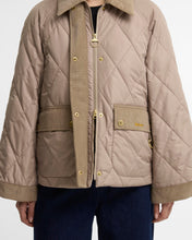 Load image into Gallery viewer, Close-up of quilted jacket with gold zipper, snap buttons, and corduroy trim details