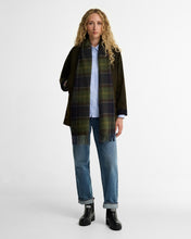 Load image into Gallery viewer, Model wearing Barbour Halton black chelsea wellies with jeans and olive jacket