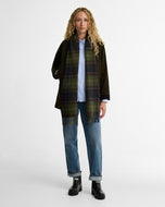Model wearing Barbour Halton black chelsea wellies with jeans and olive jacket