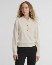 Load image into Gallery viewer, Woman wearing a cream long-sleeve knit polo sweater with gold buttons and collar