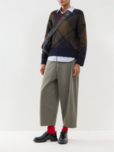 Load image into Gallery viewer, Model wearing a plaid knit pullover sweater layered over a striped shirt with wide-leg trousers