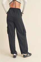 Load image into Gallery viewer, Woman wearing relaxed-fit cargo pants with side pockets and cuffed ankles